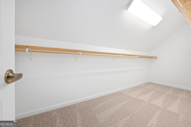 walk in closet featuring carpet and lofted ceiling