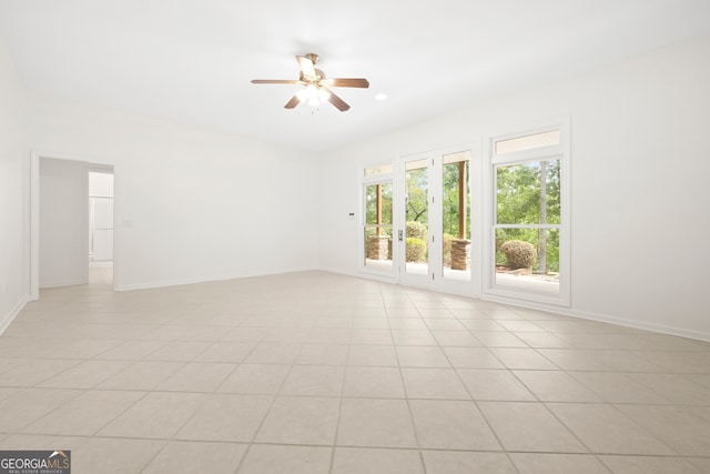 unfurnished room with ceiling fan and light tile patterned floors