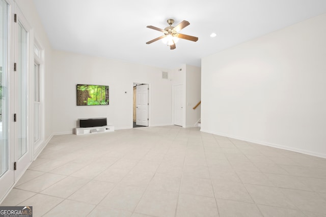 unfurnished living room featuring ceiling fan and light tile patterned flooring