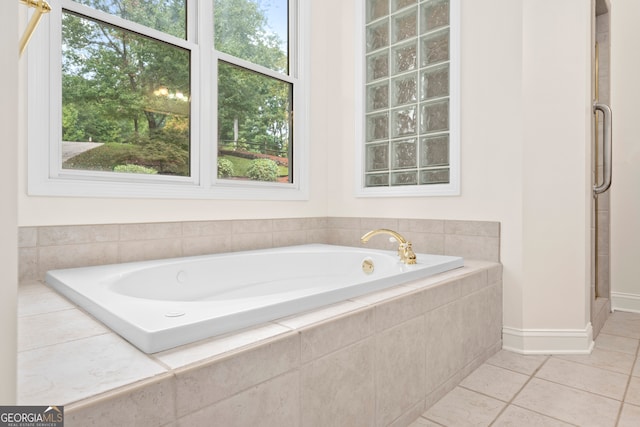 bathroom featuring independent shower and bath and tile patterned flooring