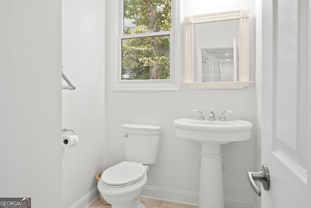 bathroom featuring toilet and tile patterned flooring