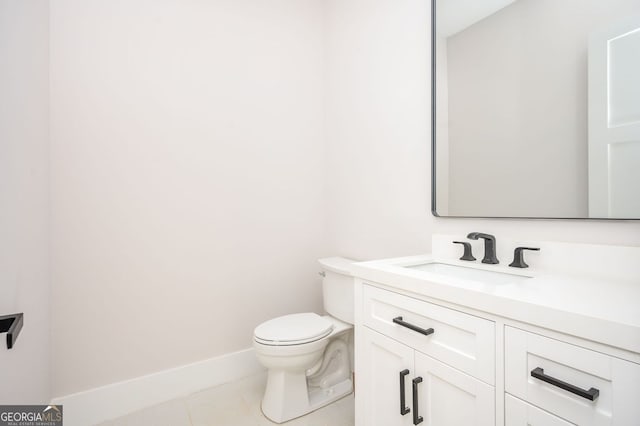 bathroom with tile patterned floors, vanity, and toilet