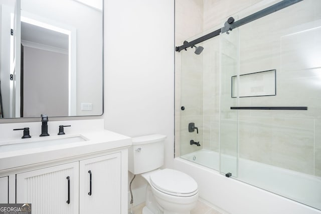 full bathroom featuring vanity, crown molding, bath / shower combo with glass door, and toilet