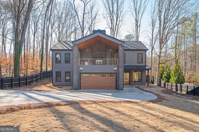 view of front of property featuring a garage and a balcony