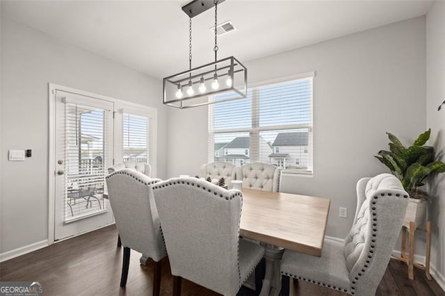 dining space featuring dark hardwood / wood-style floors