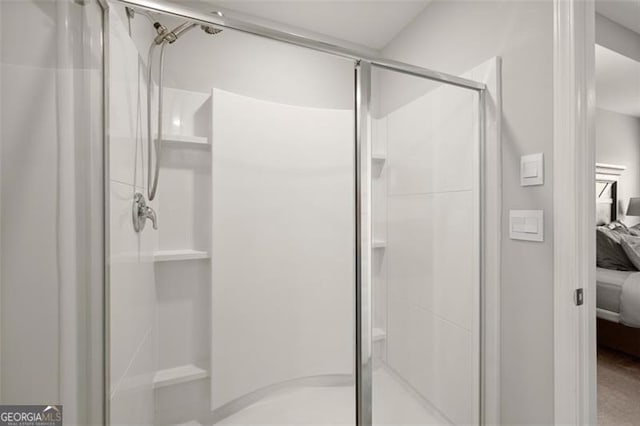 bathroom with a shower with door