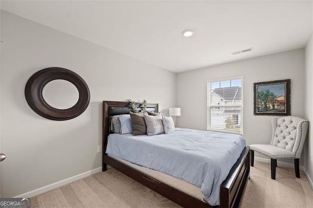 bedroom with light colored carpet