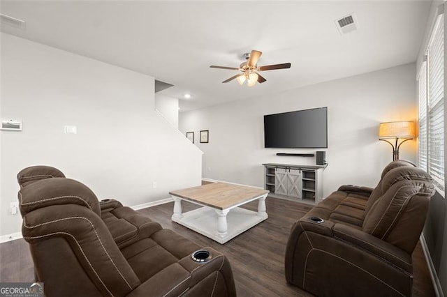 living room with dark wood-type flooring and ceiling fan