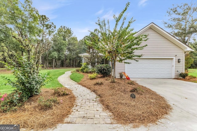 exterior space with a garage and a lawn