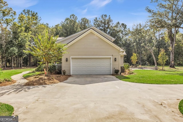 view of home's exterior featuring a yard, a garage, and central AC unit