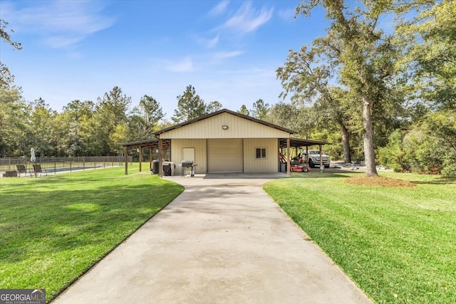 exterior space with a front yard, an outbuilding, a garage, and a carport