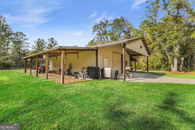 back of house with a yard and a patio area