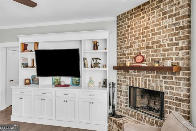 living room with dark wood-type flooring and a brick fireplace