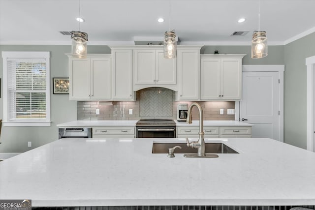 kitchen with white cabinets, a kitchen island with sink, stainless steel range with electric cooktop, and pendant lighting