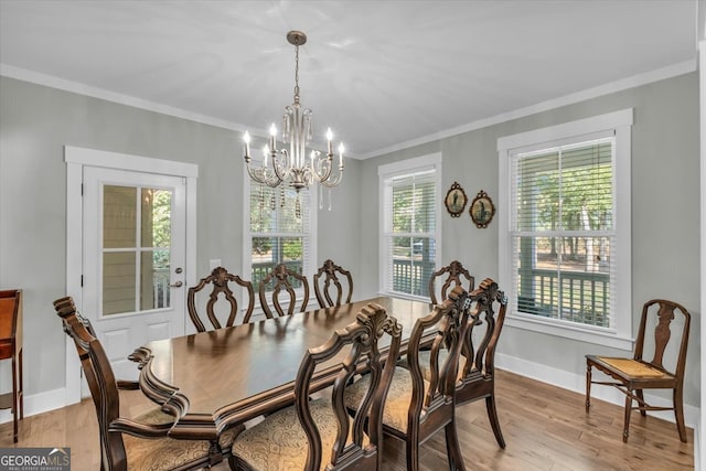 dining space with crown molding, light hardwood / wood-style flooring, and a healthy amount of sunlight