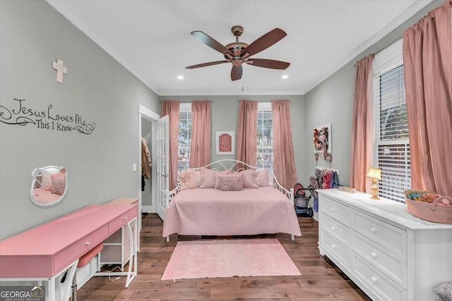 bedroom with ceiling fan and dark hardwood / wood-style flooring