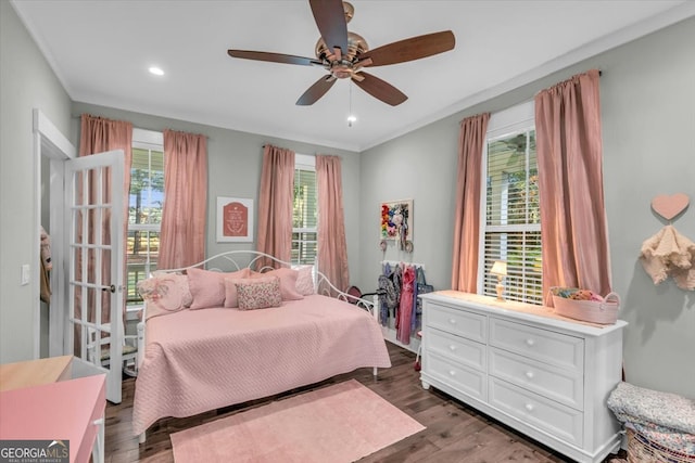 bedroom featuring crown molding, dark wood-type flooring, and ceiling fan