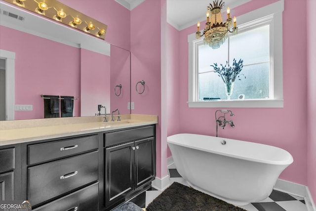 bathroom featuring vanity, ornamental molding, an inviting chandelier, and a washtub