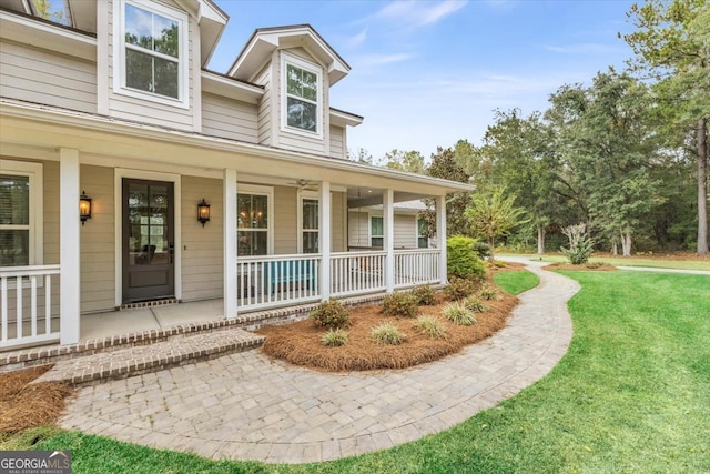 entrance to property with a yard and a porch