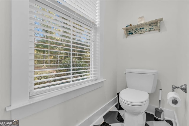 bathroom featuring toilet and tile patterned floors