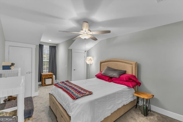 carpeted bedroom featuring lofted ceiling and ceiling fan