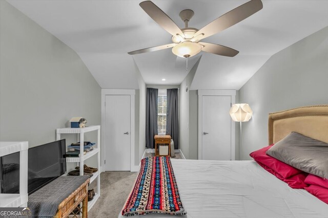 carpeted bedroom featuring vaulted ceiling and ceiling fan