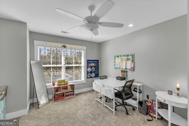 office space with light carpet and ceiling fan