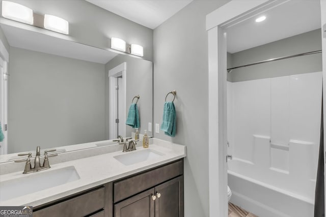 full bathroom with toilet, vanity, wood-type flooring, and shower / tub combo