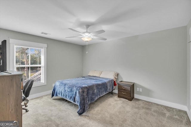 bedroom with ceiling fan and light carpet