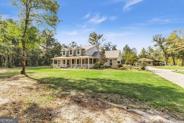 cape cod house with covered porch, a front yard, and a garage