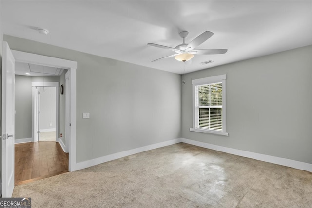 carpeted spare room featuring ceiling fan