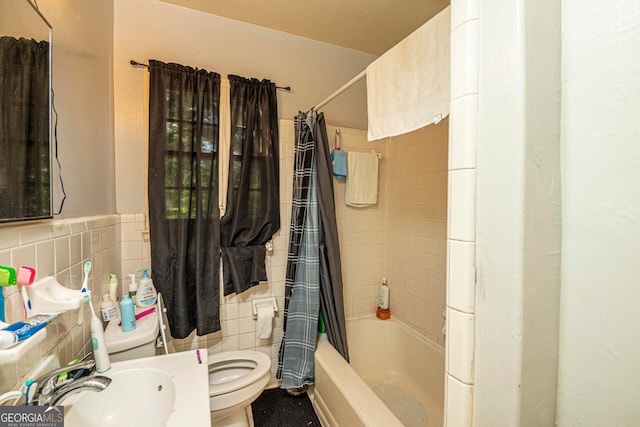 full bathroom with tile walls, sink, shower / bath combination with curtain, and toilet