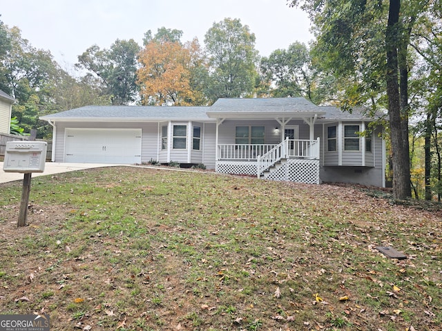 ranch-style home with covered porch, a front lawn, and a garage