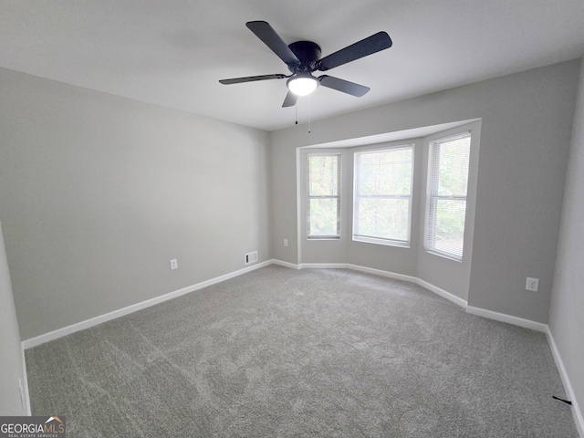 empty room featuring carpet and ceiling fan