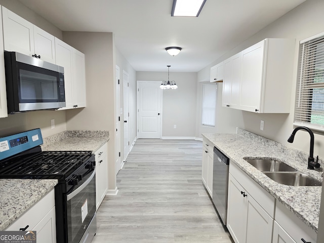 kitchen with sink, appliances with stainless steel finishes, and white cabinets