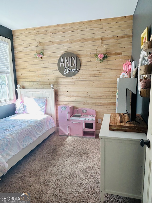 carpeted bedroom featuring wooden walls