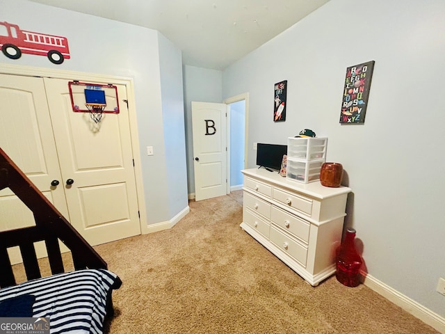 bedroom featuring light colored carpet and a closet