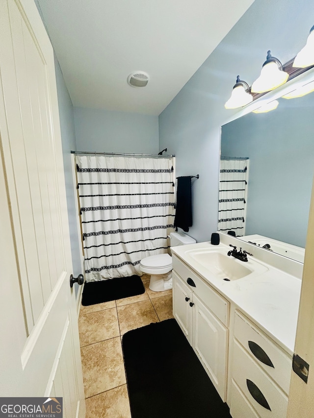 bathroom with curtained shower, tile patterned flooring, vanity, and toilet