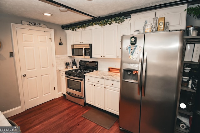 kitchen with stainless steel appliances, dark wood-type flooring, decorative backsplash, a textured ceiling, and white cabinetry