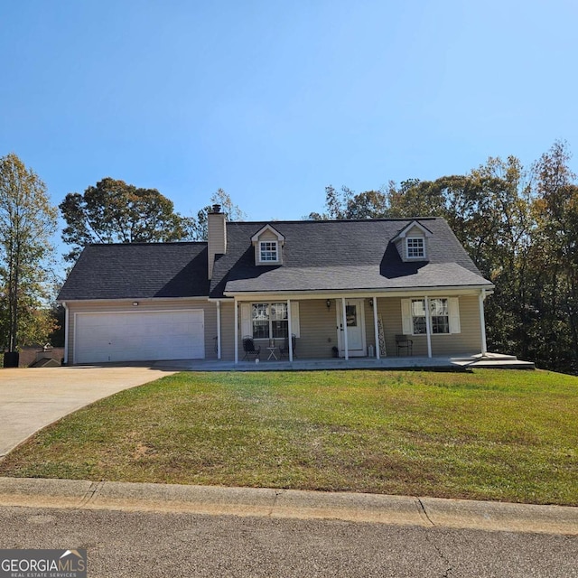 view of front of property with a garage, a front lawn, and a porch