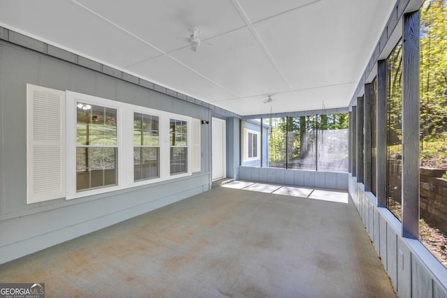 unfurnished sunroom with ceiling fan