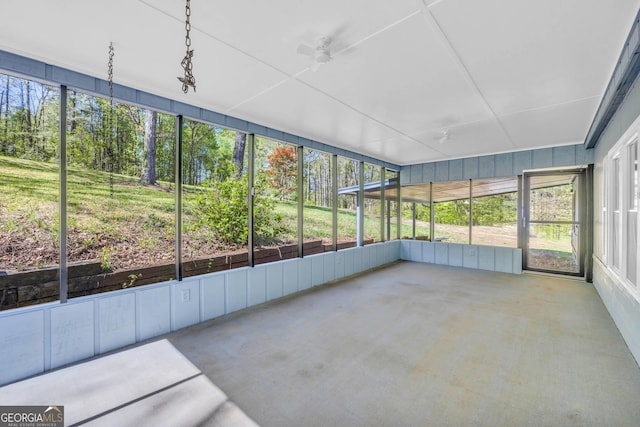 unfurnished sunroom with plenty of natural light and ceiling fan