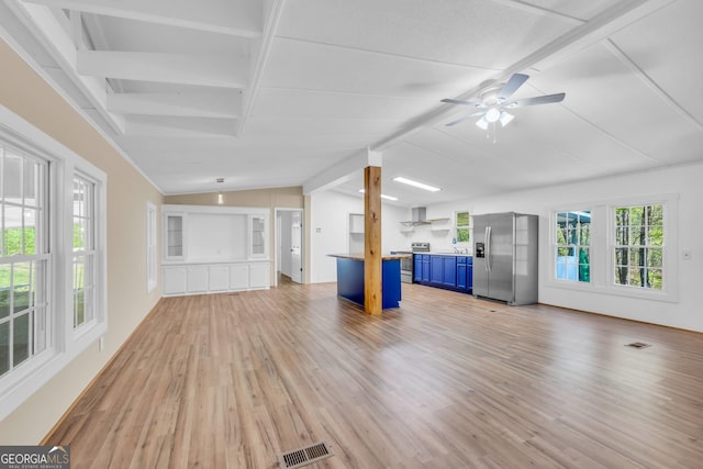 unfurnished living room with vaulted ceiling with beams, ceiling fan, and light hardwood / wood-style floors