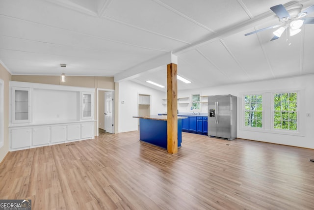 unfurnished living room with light hardwood / wood-style flooring, lofted ceiling with beams, sink, and ceiling fan