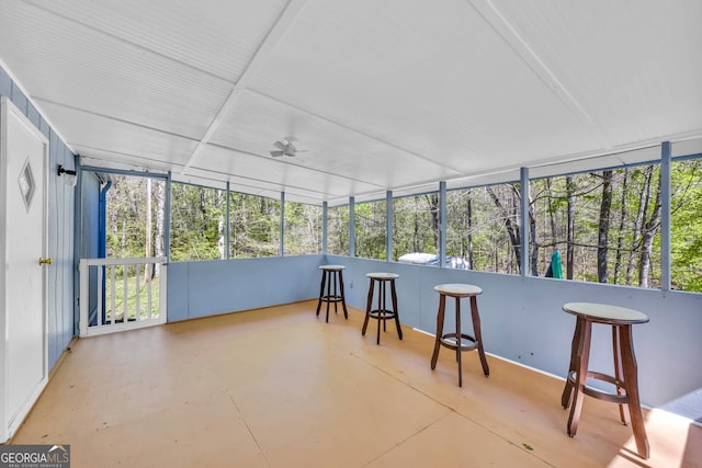 sunroom / solarium featuring ceiling fan