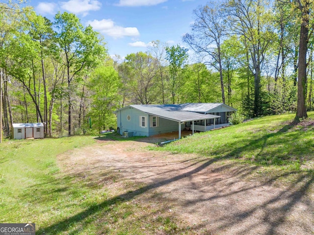 rear view of property featuring a yard