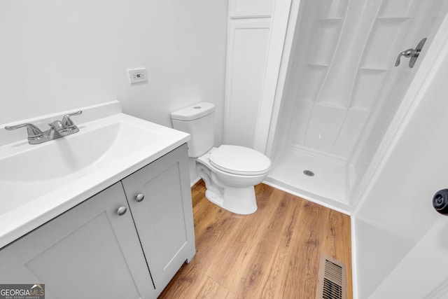 bathroom featuring vanity, toilet, a shower with curtain, and hardwood / wood-style floors