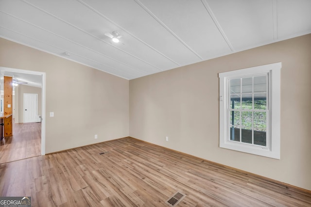 empty room featuring light hardwood / wood-style floors and lofted ceiling