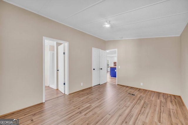 spare room featuring light wood-type flooring