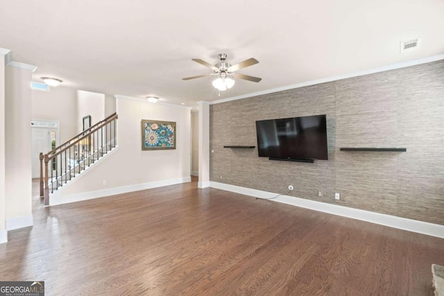 unfurnished living room featuring wood-type flooring, ceiling fan, and crown molding